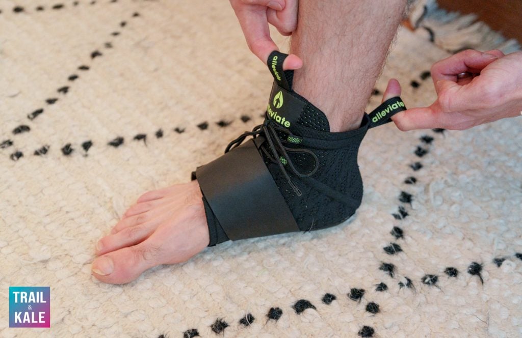 Putting on the Alleviate Therapy plantar fasciitis brace using the two useful finger loops
